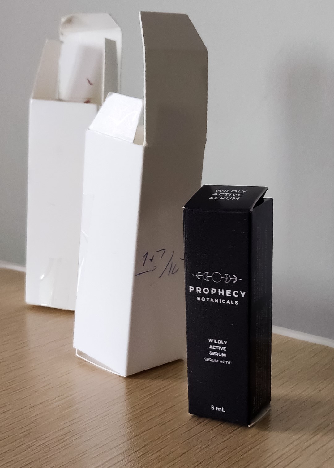 Posed shot of the final design for the two products I designed the packaging for. On the top, there is text to help know which product it is when stacked in a shelf space-saving manner. On the minor flap, there is a handwritten message from the brand owner